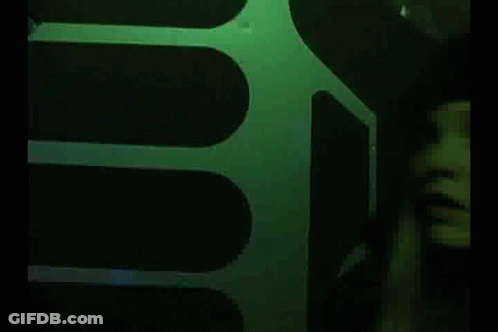 Woman In Black Hat In Dark Room GIF