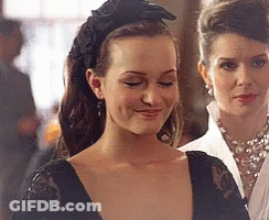 Woman In Black Headband And Earrings Smiling GIF