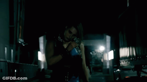 Woman In Black Holding Blue Bottle GIF