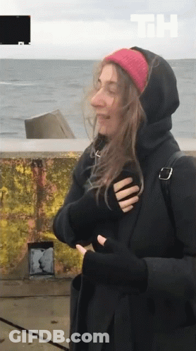 Woman In Black Hoodie And Red Beanie By Ocean GIF