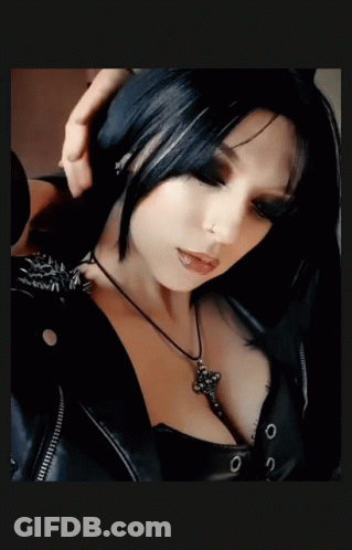 Woman In Black Jacket And Cross Necklace GIF