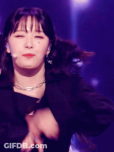 Woman In Black Jacket And Necklace Dancing With Eyes Closed GIF