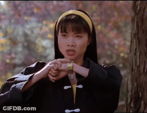 Woman In Black Jacket And Yellow Headband Holding Hands Together GIF