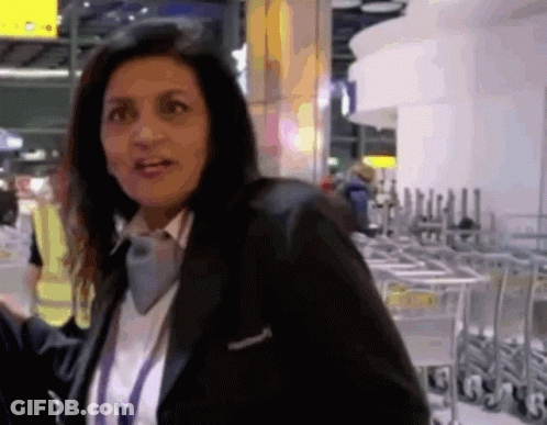 Woman In Black Jacket At Carts Marked G GIF