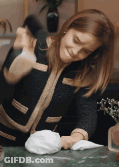 Woman In Black Jacket Cleaning Table GIF