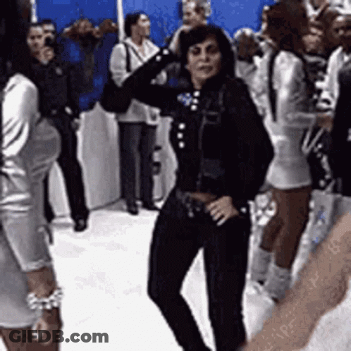 Woman In Black Jacket Dancing In Crowd GIF