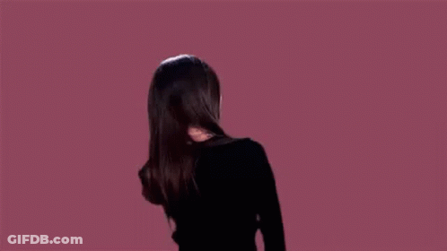 Woman In Black Jacket Dancing With Wind-Blown Hair GIF