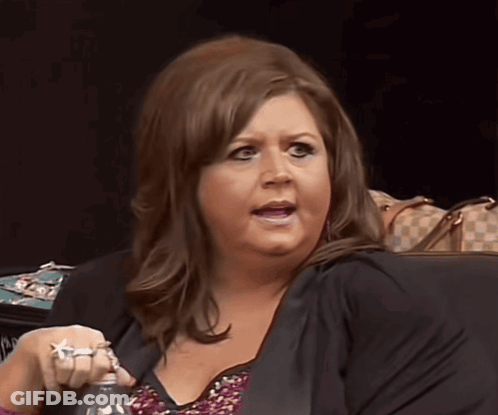Woman In Black Jacket Holding Bottle GIF