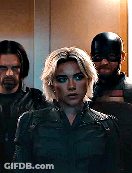 Woman In Black Jacket Next To Two Men GIF
