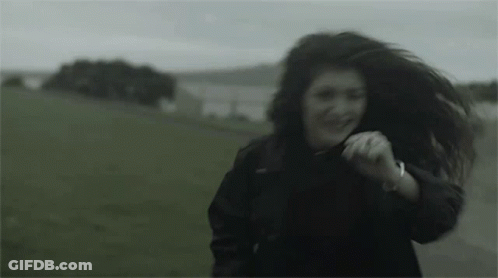 Woman In Black Jacket Running In Field GIF