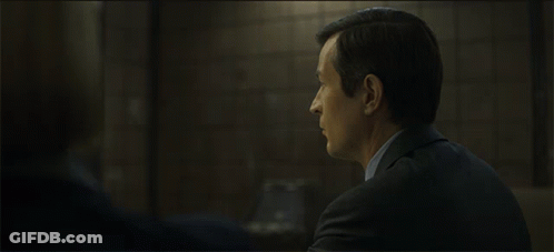 Woman In Black Jacket Talking To Man In Blue Shirt GIF