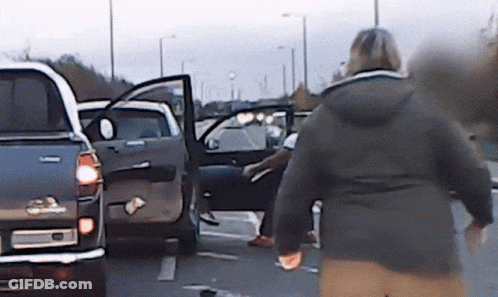 Woman In Black Jacket Walking Toward Toyota Truck GIF