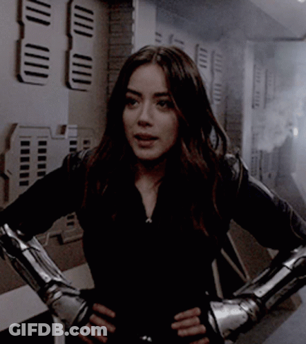 Woman In Black Jacket With Metal Gloves GIF