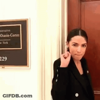 Woman In Black Jacket With Ocasio Cortez Sign GIF