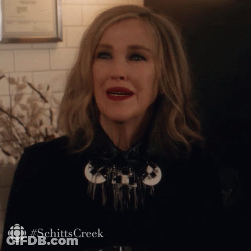 Woman In Black Jacket With Schitts Creek Hashtag GIF
