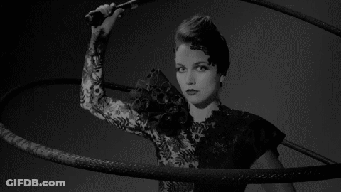 Woman In Black Lace Dress Holding Whip GIF