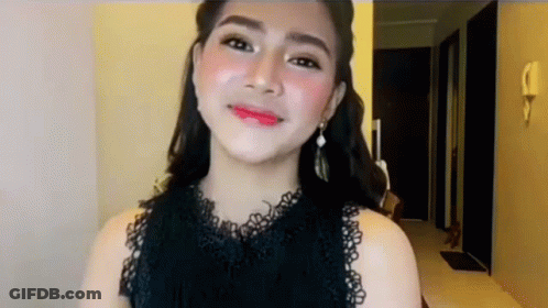 Woman In Black Lace Top And Earrings Smiling GIF