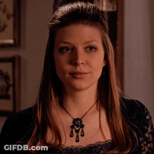 Woman In Black Lace Top And Pendant Necklace GIF