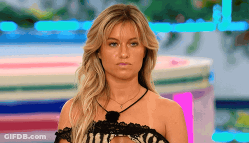 Woman In Black Lace Top Looking At Camera GIF