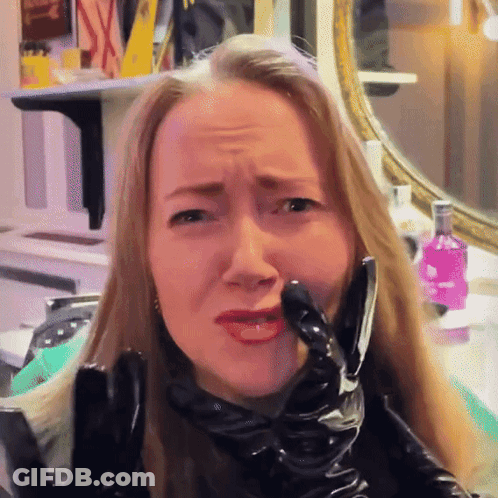 Woman In Black Latex Gloves Making Face GIF