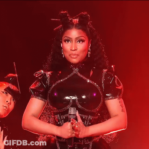 Woman In Black Latex Smiling Holding Microphone GIF