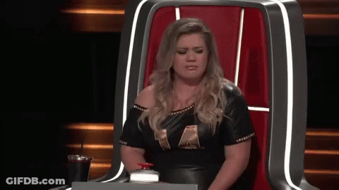Woman In Black Leather Dress Sitting With Drink GIF