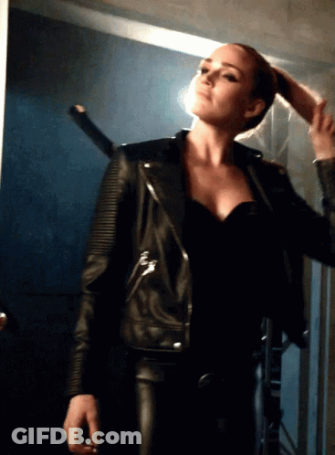 Woman In Black Leather Jacket Holding Hair GIF