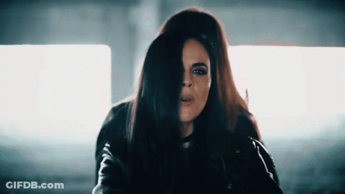 Woman In Black Leather Jacket Holding Hair GIF