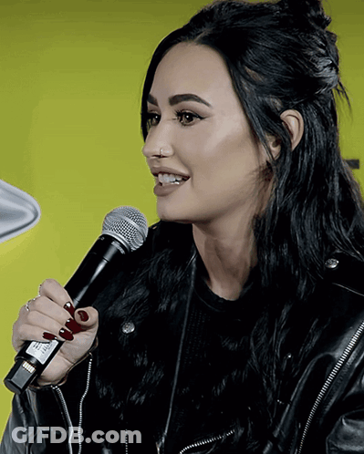 Woman In Black Leather Jacket Holding Microphone GIF