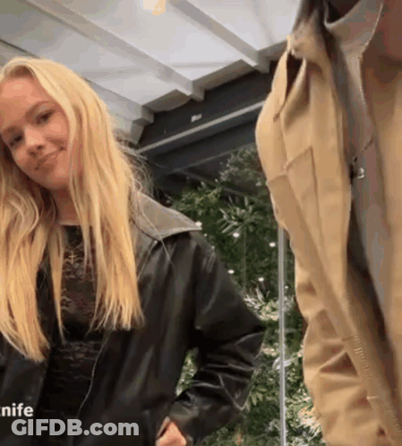 Woman In Black Leather Jacket Next To Man In Tan Jacket GIF