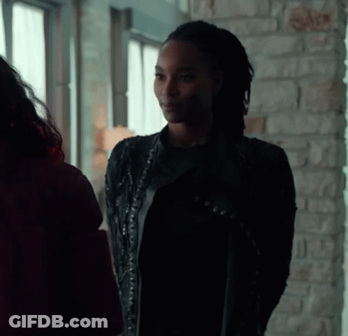 Woman In Black Leather Jacket Next To Woman In Red Jacket GIF