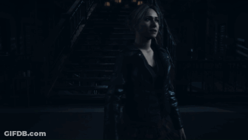 Woman In Black Leather Jacket Standing In Dark GIF