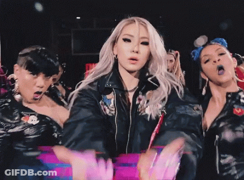 Woman In Black Leather Jacket Surrounded By Women GIF