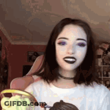 Woman In Black Lipstick And Choker Smiling With Cupcake GIF