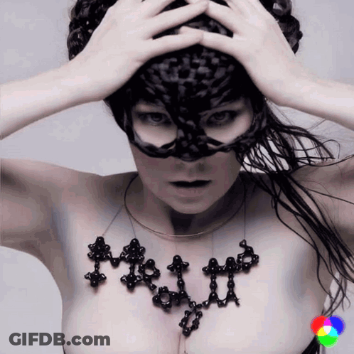 Woman In Black Mask With Necklace Saying A GIF