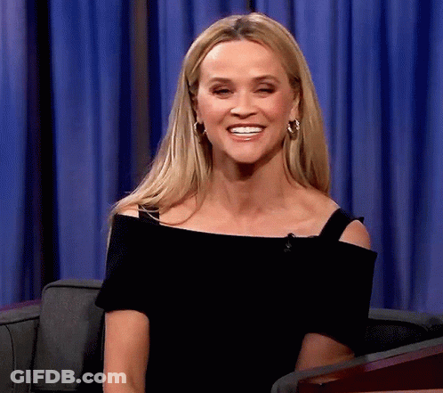 Woman In Black Off-Shoulder Top And Hoop Earrings Smiling GIF