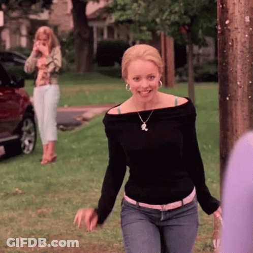 Woman In Black Off Shoulder Top And Jeans Smiling In Park GIF