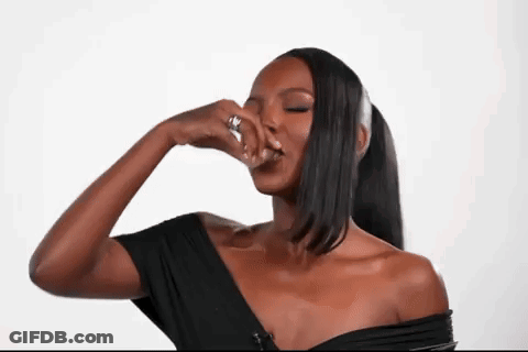 Woman In Black Off Shoulder Top Covering Nose With Hand GIF