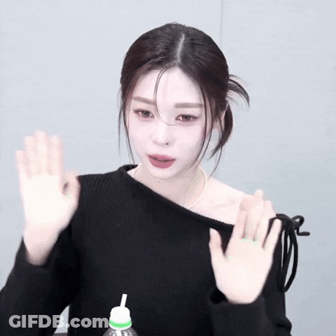 Woman In Black Off-The-Shoulder Sweater Waving GIF