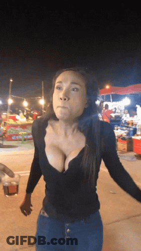 Woman In Black Plunging Top At Food Stand GIF