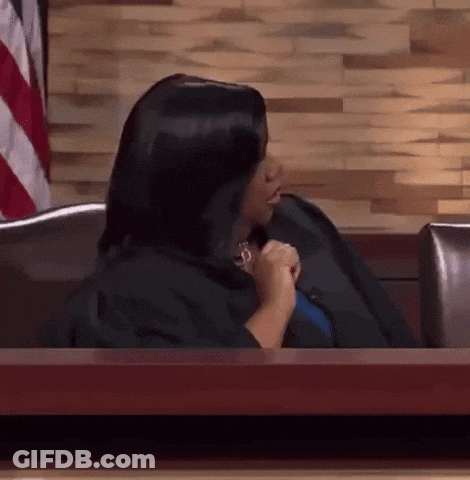Woman In Black Robe Sitting At Table GIF