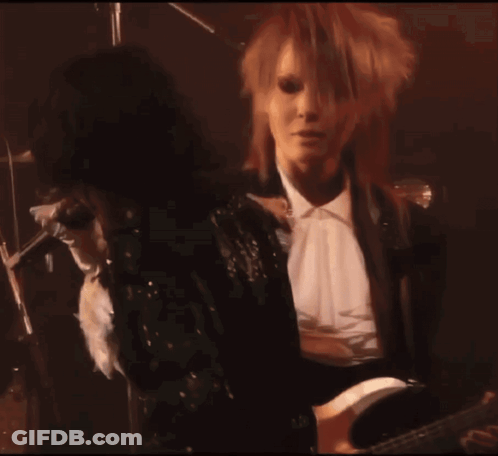 Woman In Black Sequined Jacket Standing Next To Woman GIF