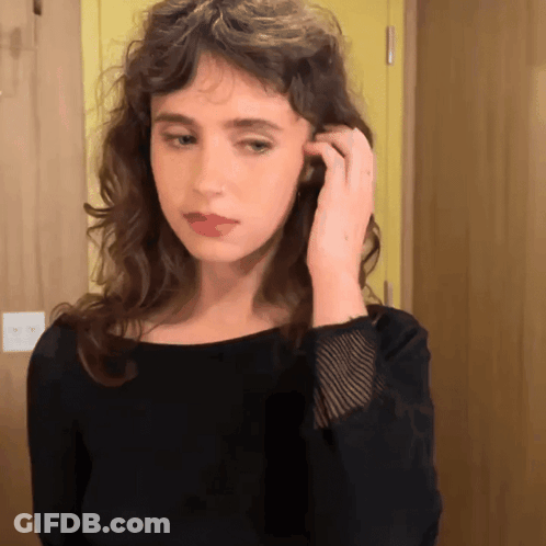 Woman In Black Shirt Adjusting Hair GIF