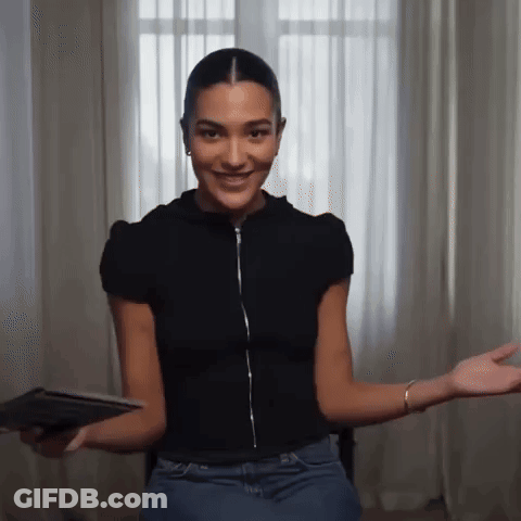 Woman In Black Shirt And Blue Jeans Sitting By Window GIF