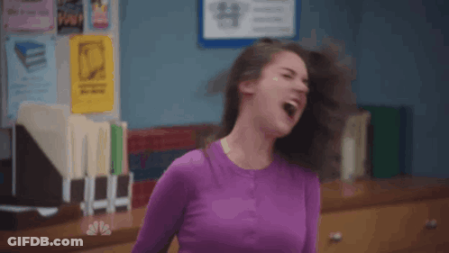 Woman In Black Shirt And Grey Cardigan GIF