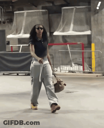Woman In Black Shirt And Grey Sweatpants With Number 3 GIF