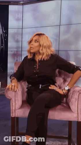 Woman In Black Shirt And Pants Sitting GIF