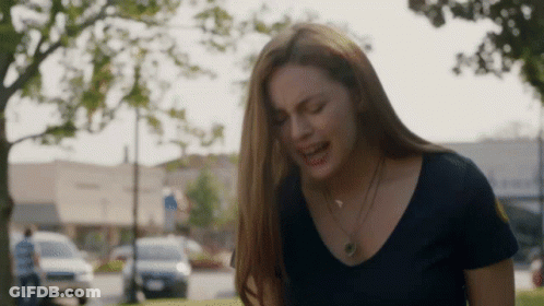 Woman In Black Shirt Crying In Park GIF