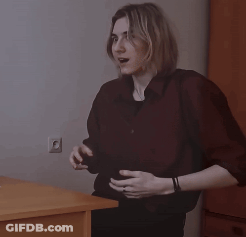 Woman In Black Shirt Giving Peace Sign GIF