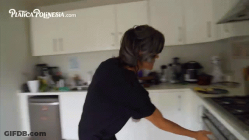 Woman In Black Shirt In Kitchen With Platica Ponesia.com GIF